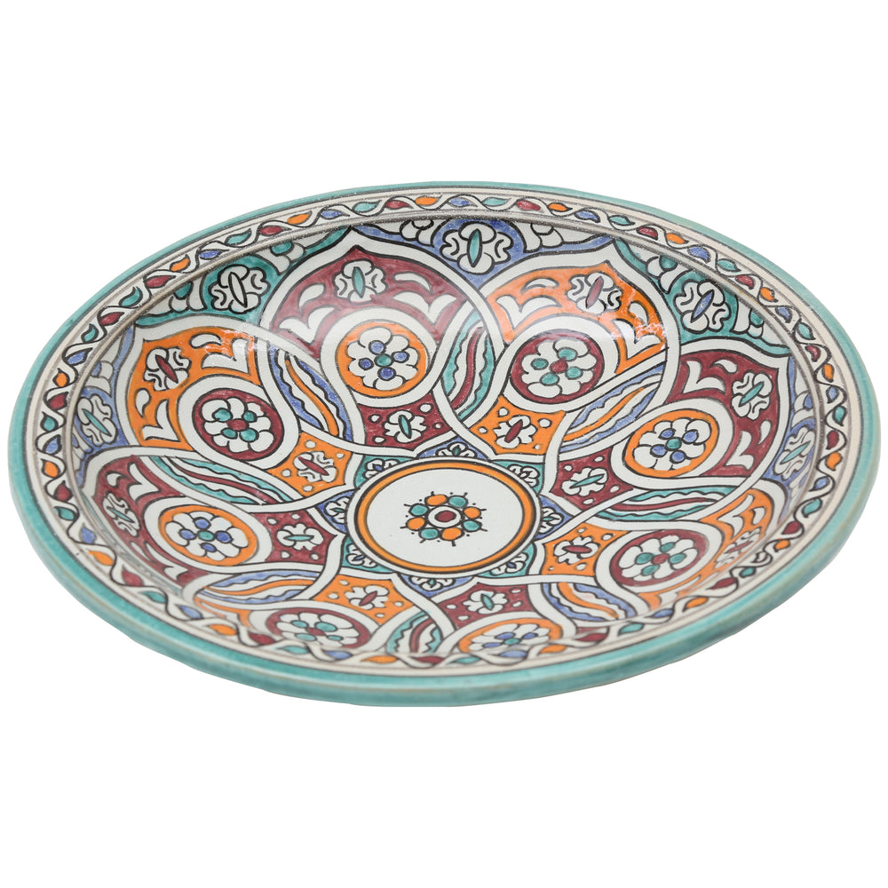 Cuenco de cerámica pintado a mano con un motivo circular entrelazado en tonos turquesa, naranja y burdeos