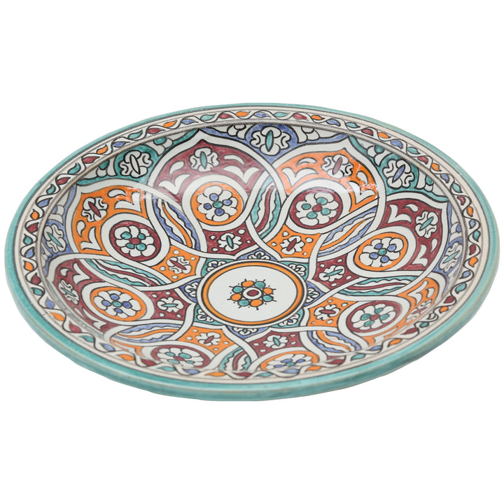 Cuenco de cerámica pintado a mano con un motivo circular entrelazado en tonos turquesa, naranja y burdeos